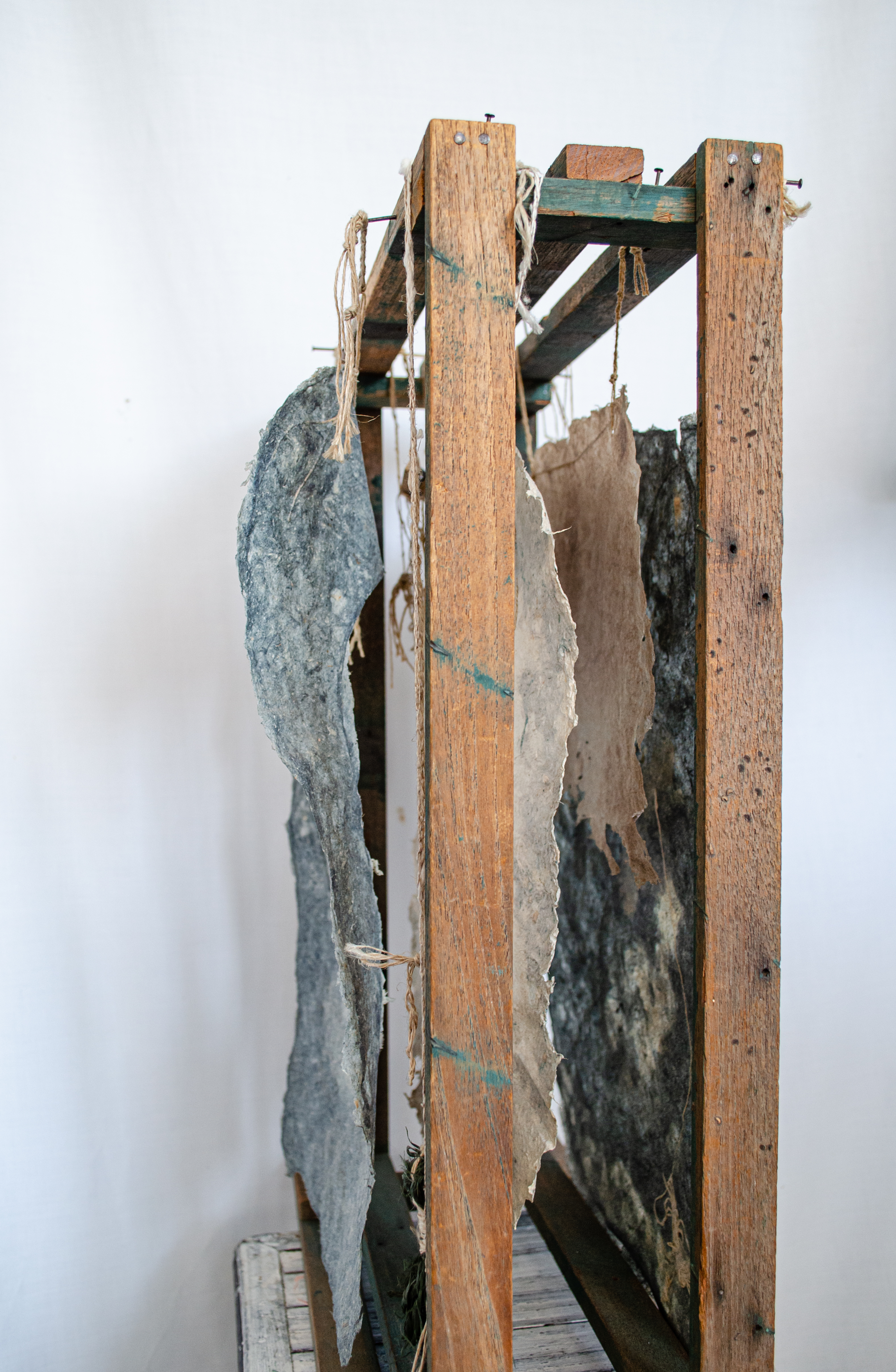 Alt text: detail of wood and flax paper sculpture construction