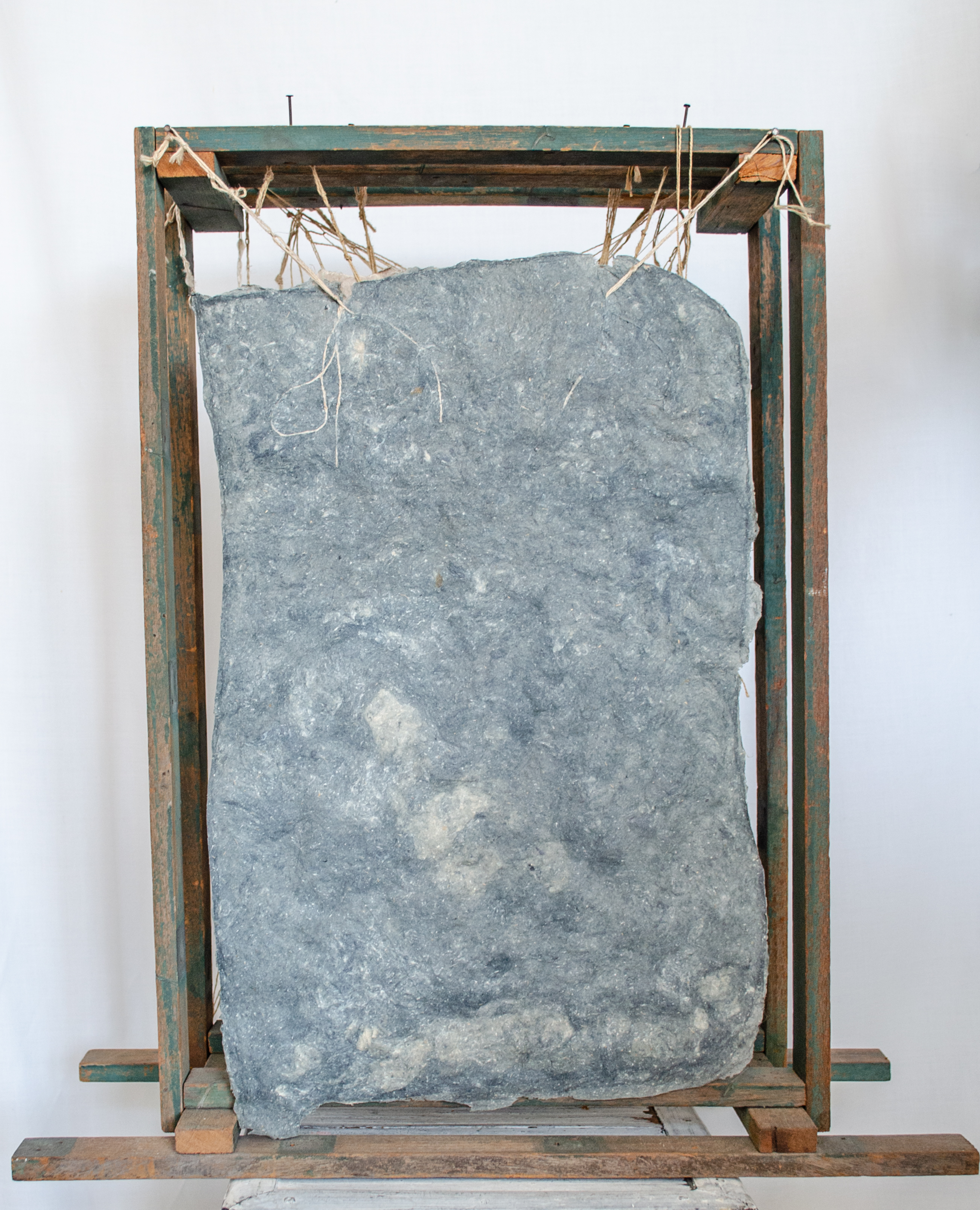 Alt text: verso of wood and flax paper sculpture construction