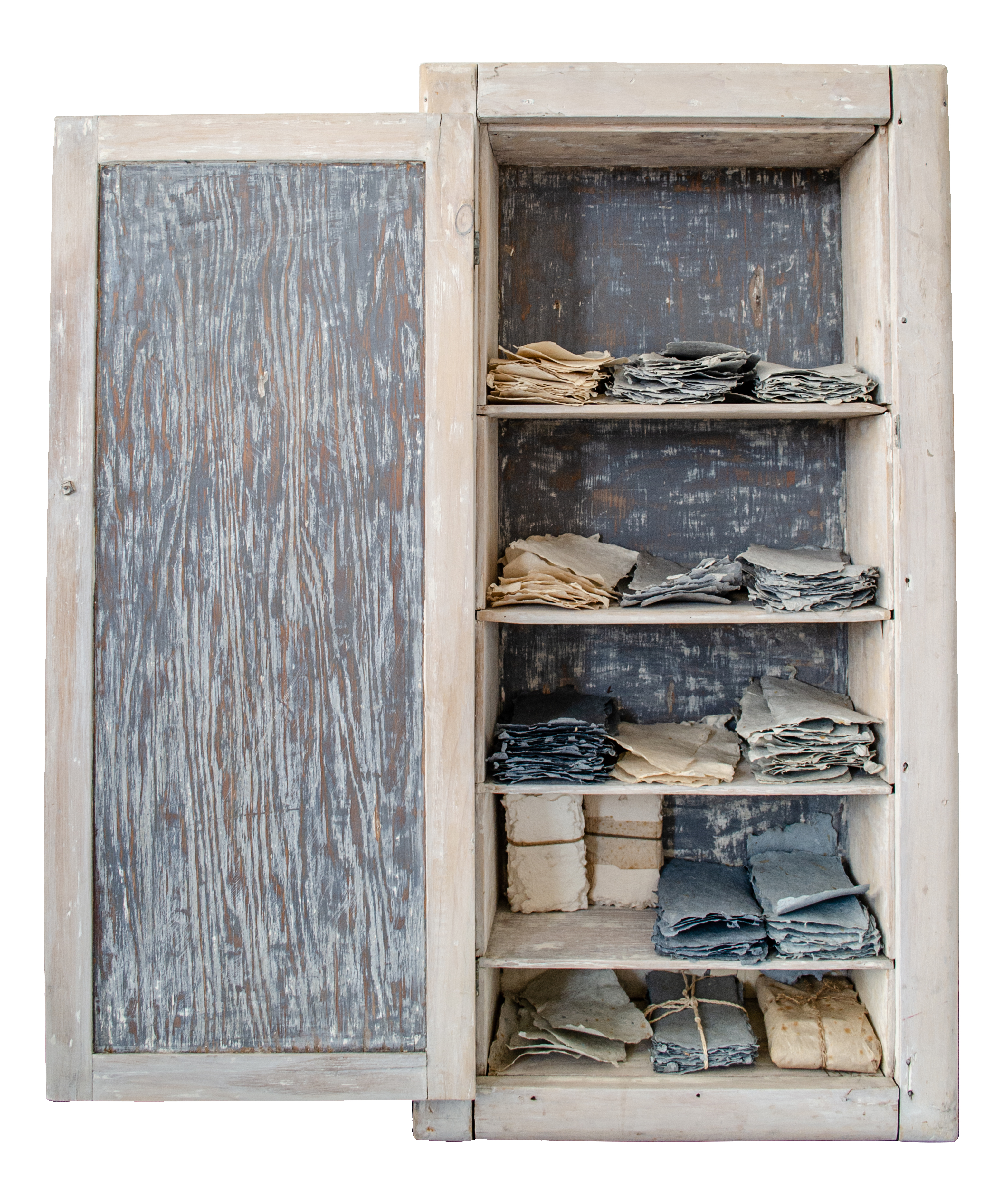 Alt text: Cupboard with scraps of handmade paper