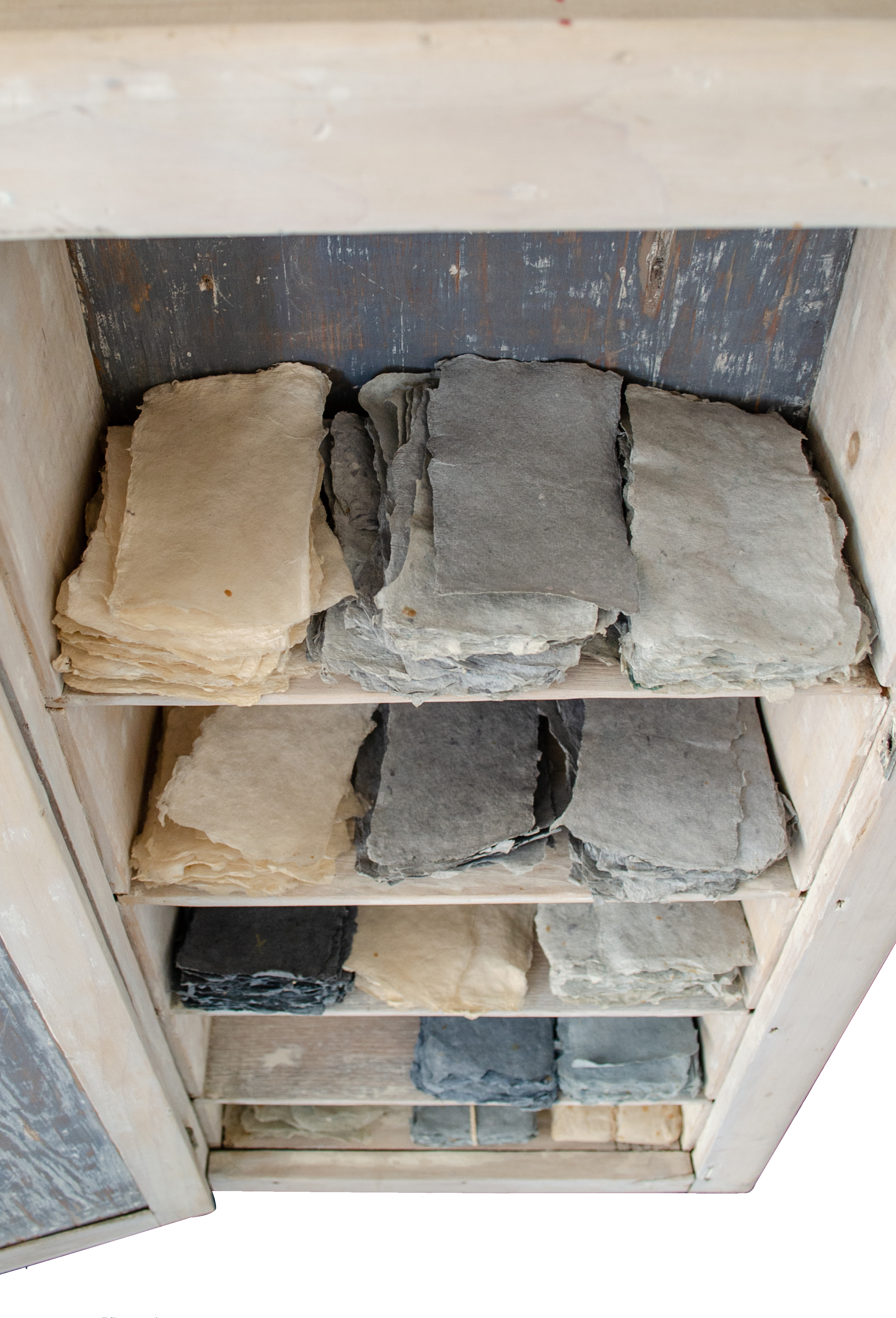 Alt text: Cupboard with scraps of handmade paper inside