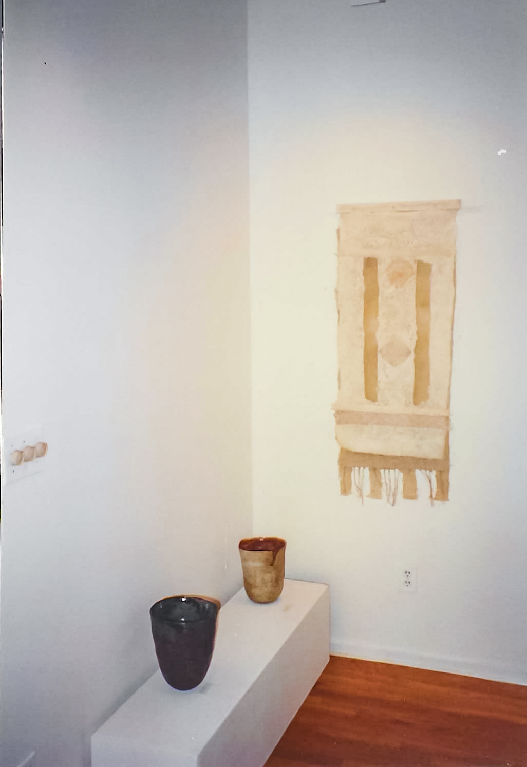 Alt text: Handmade paper wall hanging installation view