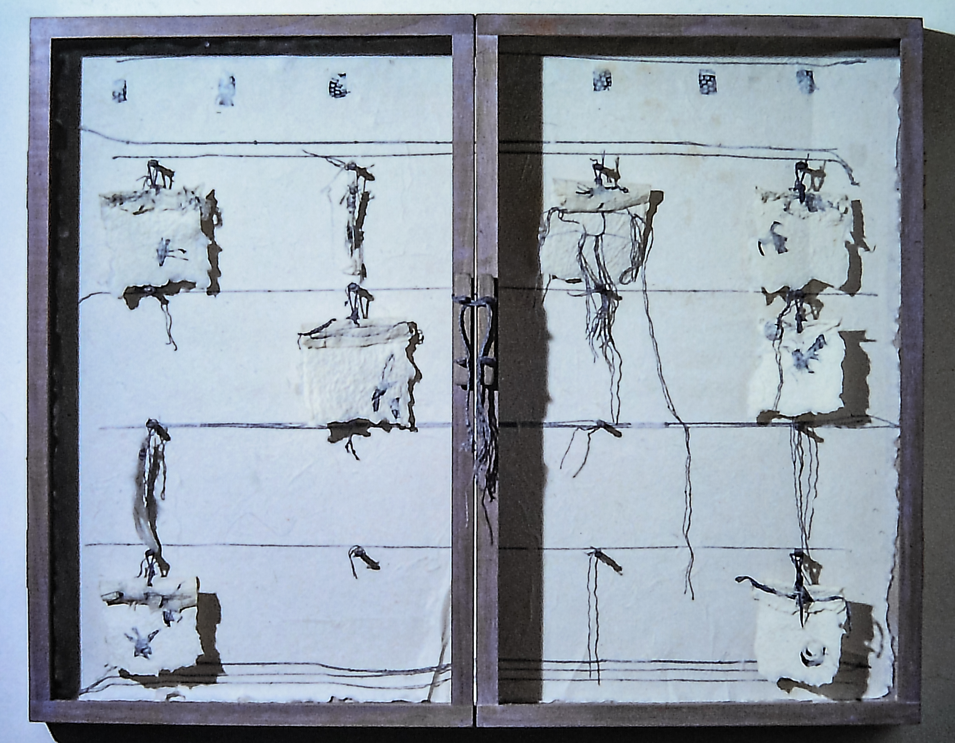 Alt text: Cabinet with fragments of handmade paper