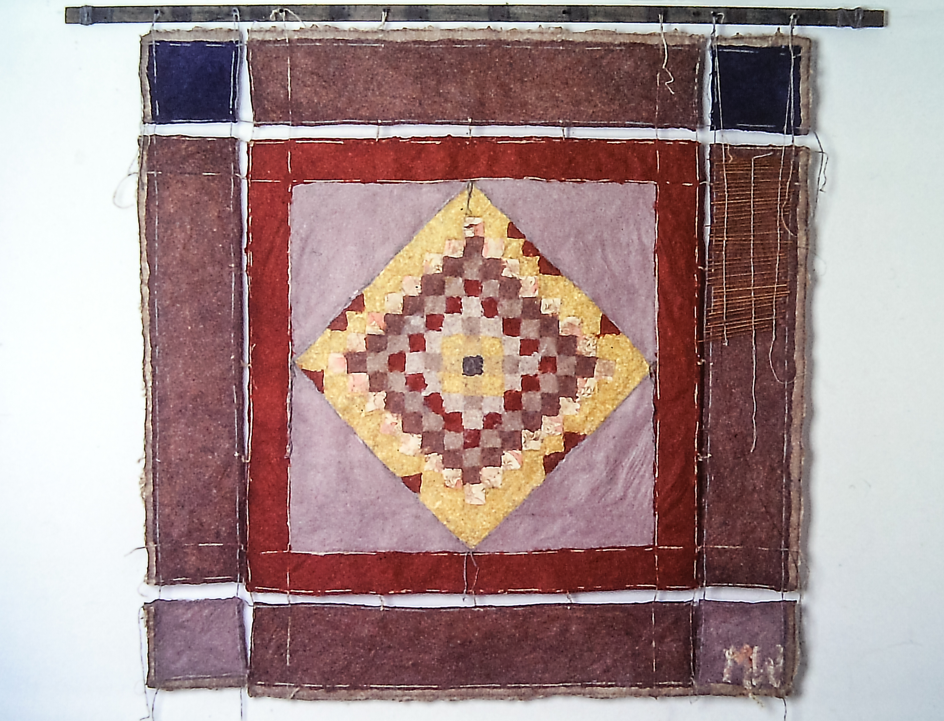 Alt text: Knitted handmade wall hanging